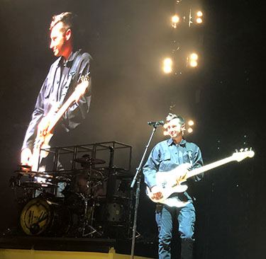 Concert picture of Tyler smiling from Twenty One Pilots.